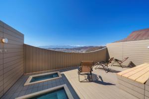a patio with chairs and a table on a building at onsen hotel OMOTO in Matsumoto
