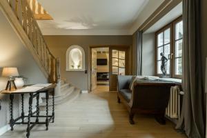 a living room with a staircase and a chair at De zandberg Vakantiewoning in Neerpelt