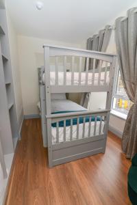 a baby crib with two bunk beds in a room at Lodge at The Old Barracks in Athenry