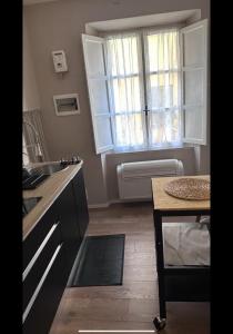 a kitchen with a sink and a window at LePetit in Porto Santo Stefano