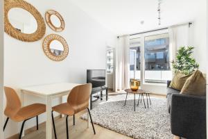 a living room with a white table and chairs at Forenom Serviced Apartments Trondheim in Trondheim