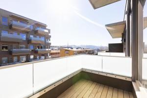 a balcony with a view of a building at Forenom Serviced Apartments Trondheim in Trondheim