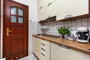 a kitchen with a sink and a counter top at HappyStay Grandma Apartment in Gdańsk