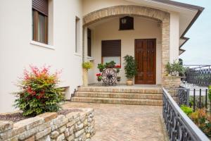 a front door of a house with a stone wall at Al Borgo Rooms in Gradara