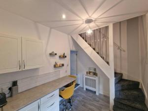 a kitchen with a staircase and a stair case at Cosy & Stylish 2 Bedroom House, King-bed & more in Hull