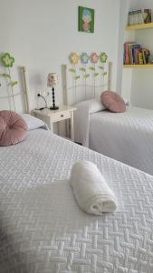a bedroom with two beds with a white comforter at Mi casa playera in El Rompido +51 photos