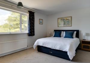 a bedroom with a large bed and a window at 10 North Warren in Aldeburgh