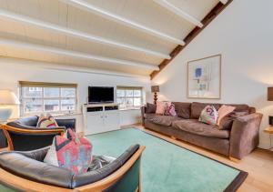 a living room with a couch and a tv at 2 The Courtyard in Snape