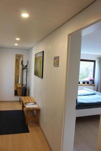a room with a bed and a table in a room at Am Barthelwald in Wilhelmsdorf