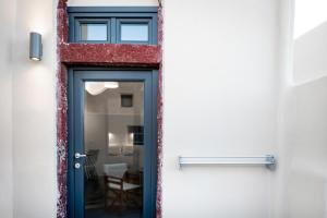 a door leading into a room with a window at Lotza Studios in Oia