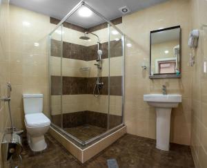 a bathroom with a shower and a toilet and a sink at Seven Boutique Hotel Baku in Baku +159 photos
