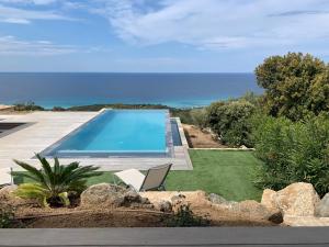 a house with a swimming pool and a yard at VILLA MACAGNA in Corbara