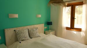 a bedroom with a bed with blue walls and a window at Villa Sal y Mar - Jávea ! Freshly Renovated ! in Jávea