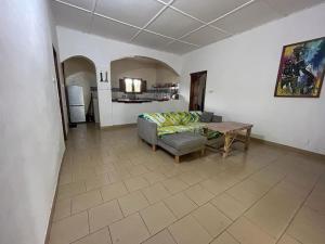 a living room with a couch and a table at Complete House in the jungle, near the sea. in Kafountine