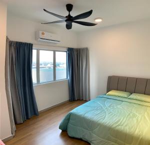 a bedroom with a bed and a ceiling fan at Paddy Village Homestay in Sekincan