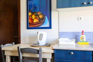 a kitchen with a table with a bowl of fruit at Villa Moras in Paralia Katerinis