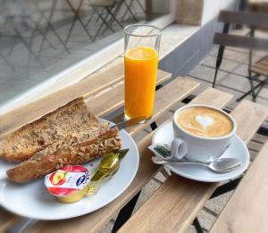 a plate of toast and a cup of coffee and orange juice at Pension Getariano in Getaria