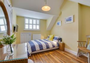 a bedroom with a bed and a table at 42 Seaview Road in Reydon