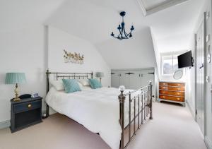 a bedroom with a large bed and a tv at 5 River Lane in Halesworth