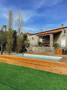 a swimming pool in the yard of a house at Casa da Nogueira in Arcos