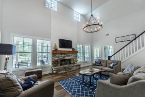 a living room with couches and a fireplace at Captain's Cove in Eatonton
