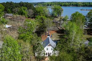 an aerial view of a house on the shore of a lake at Captain's Cove in Eatonton