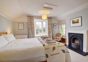 a bedroom with a large bed and a fireplace at 4 Doric Place in Woodbridge