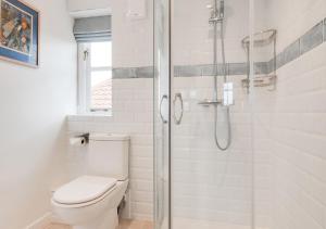 a bathroom with a toilet and a glass shower at 9 King Street in Aldeburgh