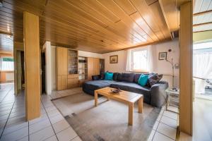a living room with a couch and a table at Ferienwohnung Schmid in Tübingen