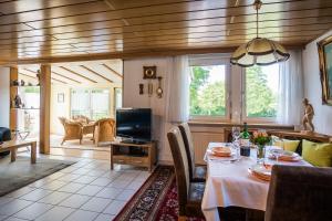 a dining room with a table and a tv at Ferienwohnung Schmid in Tübingen +26 photos