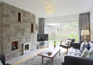 a living room with a stone wall at Arva in Southwold