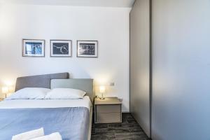 um quarto com uma cama e uma mesa lateral com um candeeiro em San Siro Green em Milão