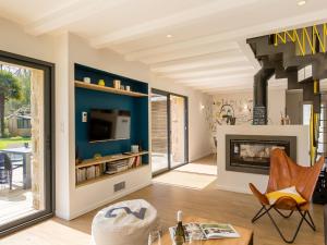 a living room with a fireplace and a tv at Holiday Home Breizh Riviera by Interhome in Bénodet +30 photos