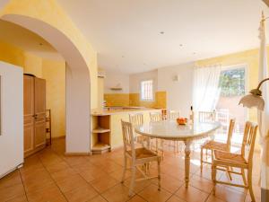 a kitchen and dining room with a table and chairs at Villa La Figuière by Interhome in La Nartelle