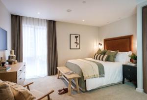 a bedroom with a bed and a desk and a chair at Apartment 21 Hudson Quarter Luxury Apartments in York