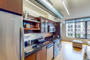 a kitchen with a refrigerator and a stove top oven at Life is Grand in Los Angeles