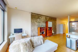 a living room with a white couch and a television at Life is Grand in Los Angeles