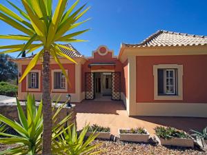 a house with a palm tree in front of it at Holiday Home Montinho by Interhome in Loulé +50 photos