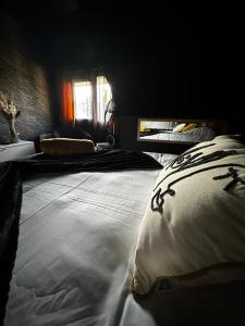 a bedroom with a large bed with white pillows at LES TEMPS HEUREUX exclusivement Familles in Quimper