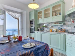 a kitchen with a table with a blue table cloth at Apartment Al Tramonto by Interhome in Portoferraio