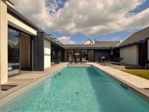 a swimming pool in the backyard of a house at Holiday Home Villa Noalou by Interhome in Arzon