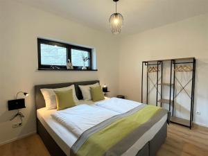 a large bed in a room with a window at Chalet Wildenbach by Interhome in Grafenweg