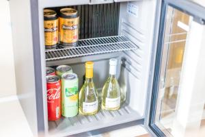 a refrigerator filled with bottles of wine and cans at Hotel Restaurant Toxopeus in Anjum +31 photos
