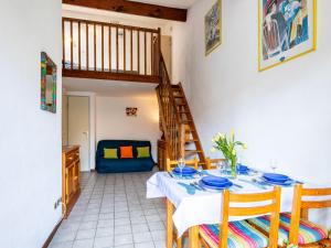 a dining room with a table and a staircase at Holiday Home Hameau de Talaris-4 by Interhome in La Palmyre