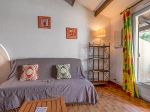 a room with a bed and a table and a window at Holiday Home Les Maisons de la Plage-7 by Interhome in Le Grau-du-Roi