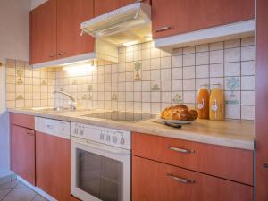 a kitchen with a sink and a plate of bread at Apartment Heida A 5 by Interhome in Ovronnaz