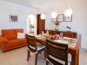 a kitchen and living room with a table and chairs at Holiday Home Cecile by Interhome in La Canuta