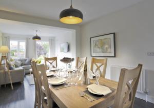 a dining room and living room with a table and chairs at Bon Amis in Southwold