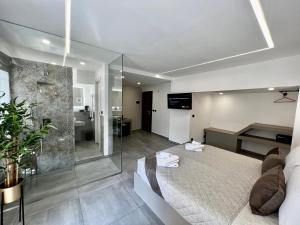 a bedroom with a large bed and a bathroom at Palermo Inn Boutique ApartHotel in Palermo