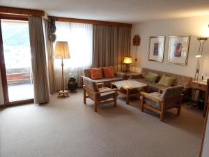 ein Wohnzimmer mit einem Sofa und einem Tisch in der Unterkunft Apartment Guardaval - Utoring-33 by Interhome in Davos